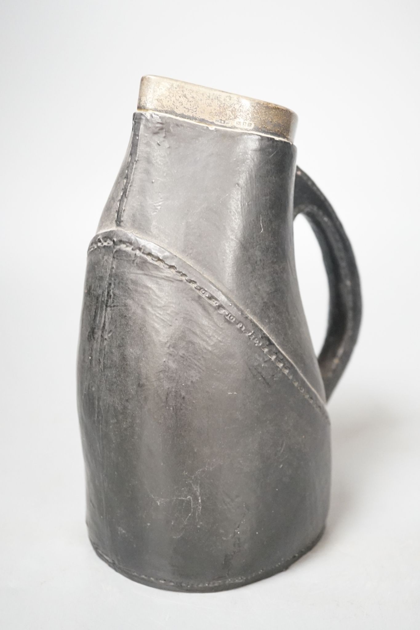 A Doulton Lambeth silver-mounted Black Jack, circa 1895. 22cm